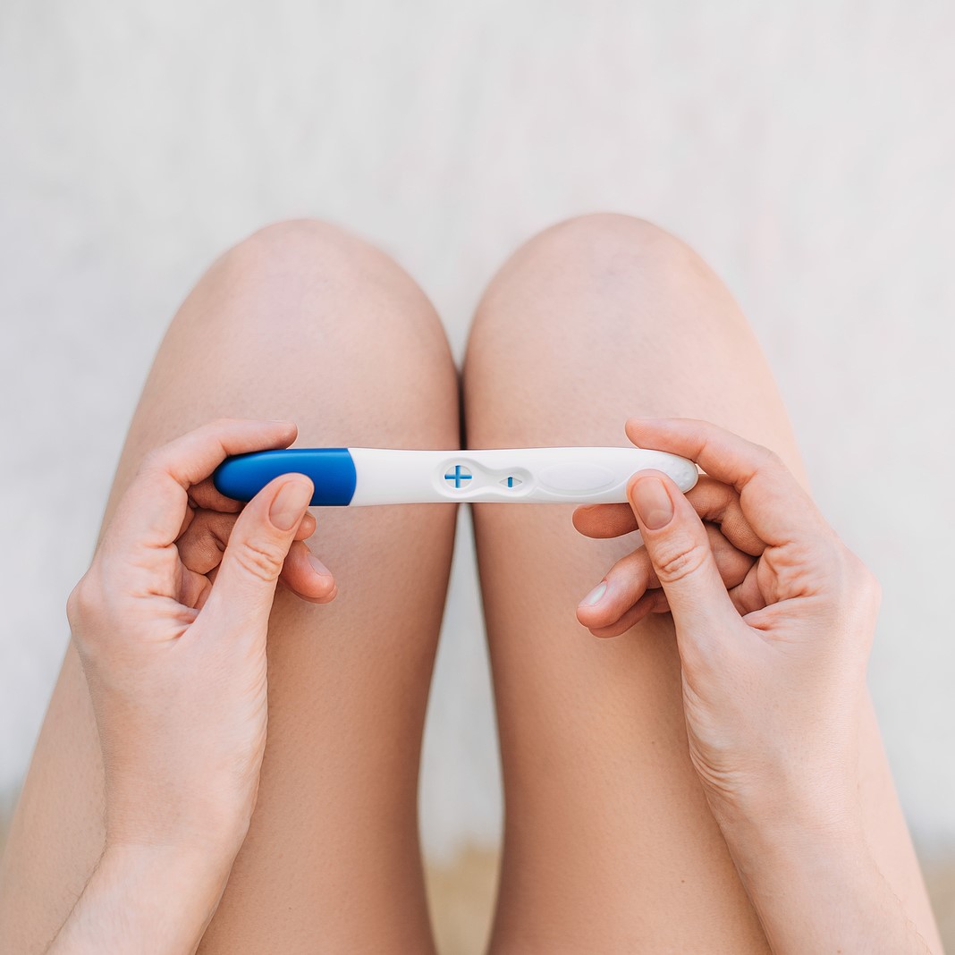 A woman holding a free pregnancy test in Cedar Rapids, Iowa