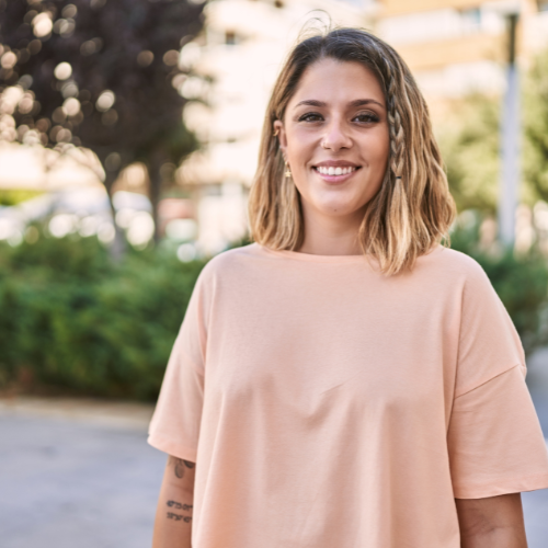 A woman smiling because she knows Bridgehaven Pregnancy Support Center offers free pregnancy services and support in Cedar Rapids, Iowa