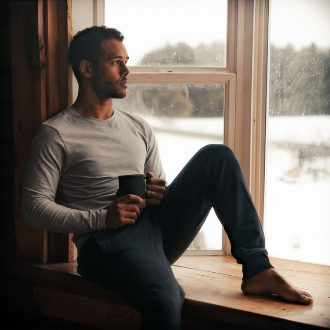 man pondering out the window